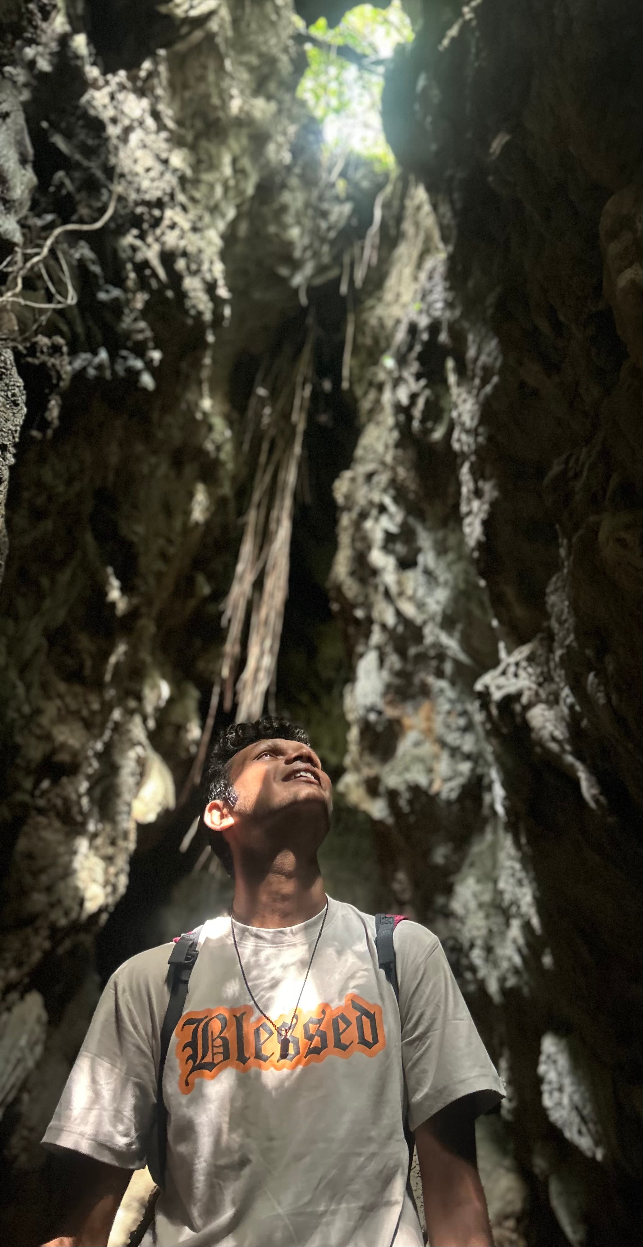 Portrait of Pranav Deepak in a sunlit cave.